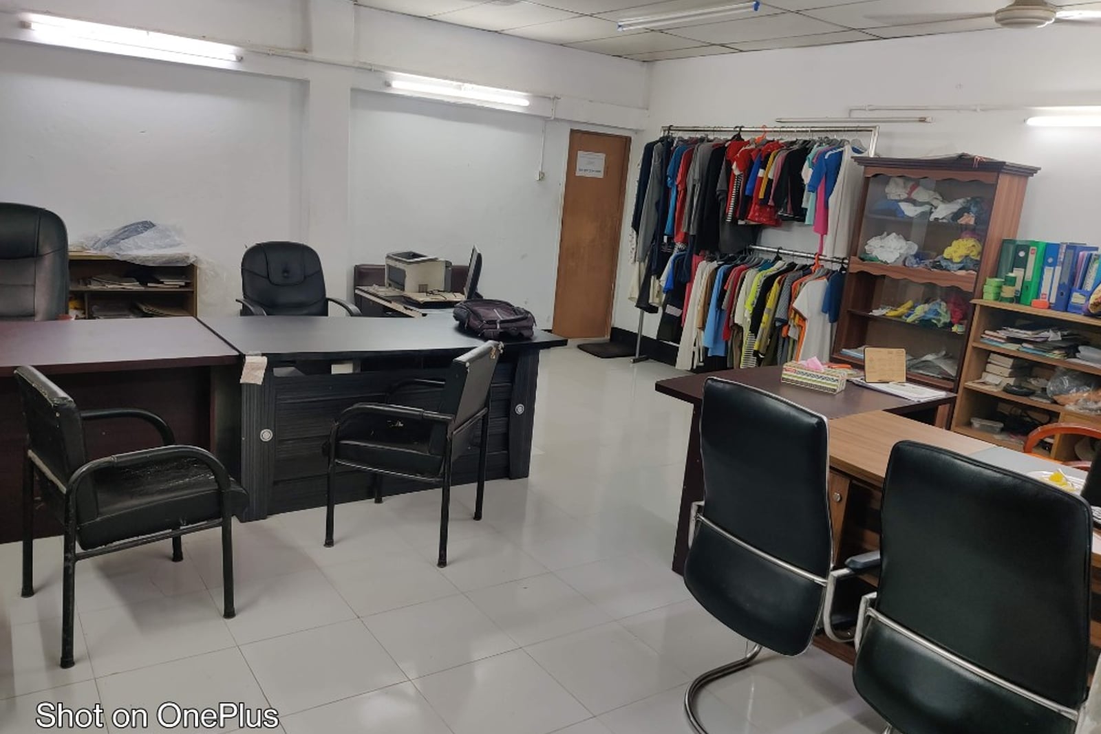 H & MR Supply Chain garments office — desks, sample hanging rail and production files